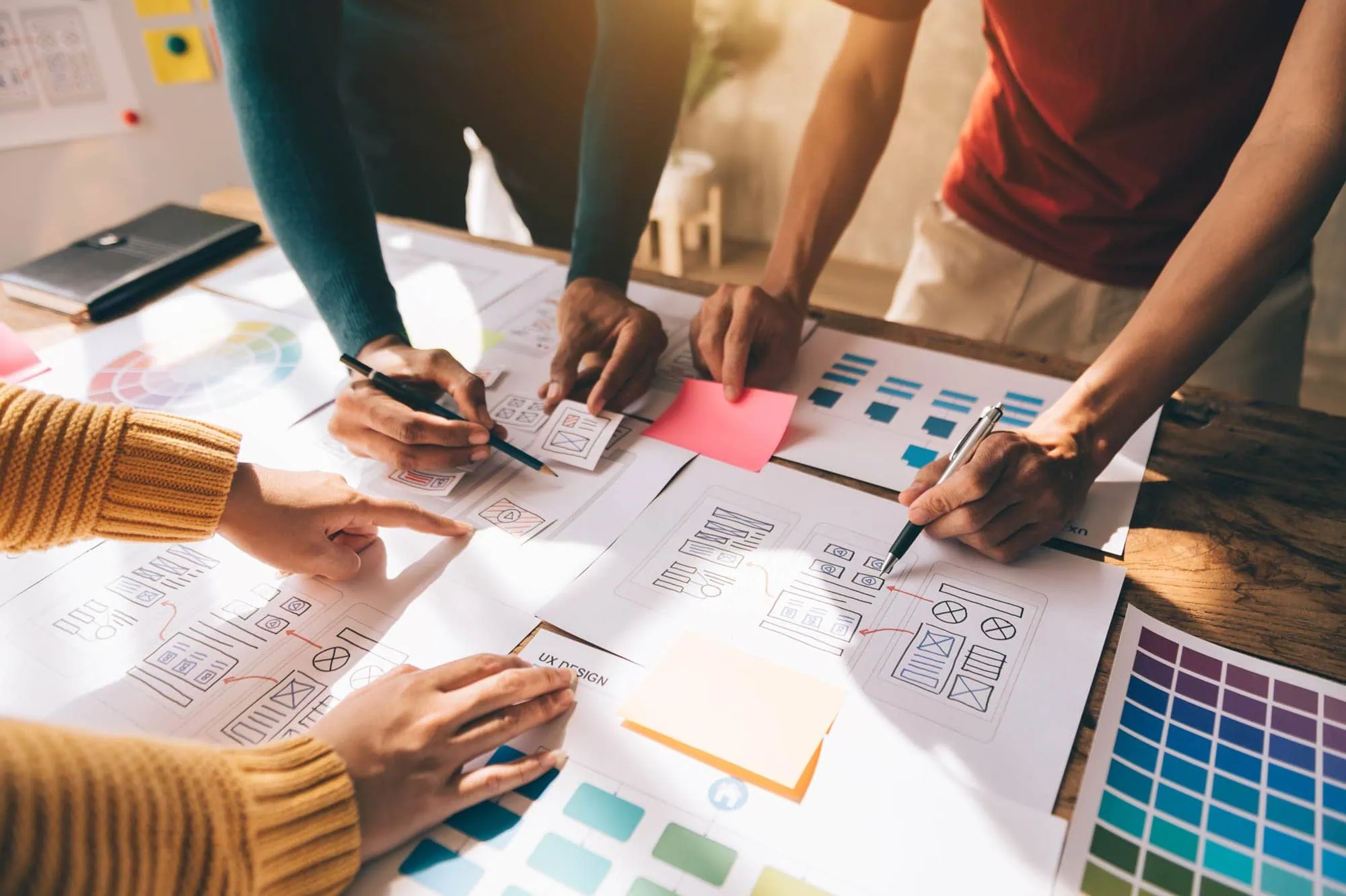 tinybox creative - Bristol creative agency web professionals around a table discussing UX and website strategies.